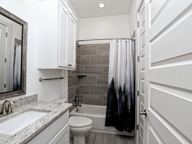 full bathroom featuring shower / tub combo, vanity, and toilet