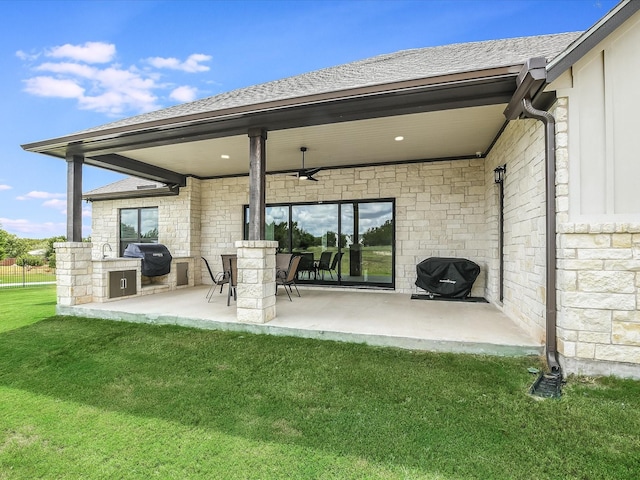 back of house featuring a patio area, a yard, and area for grilling