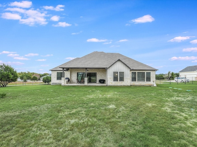 rear view of house featuring a lawn and a patio area