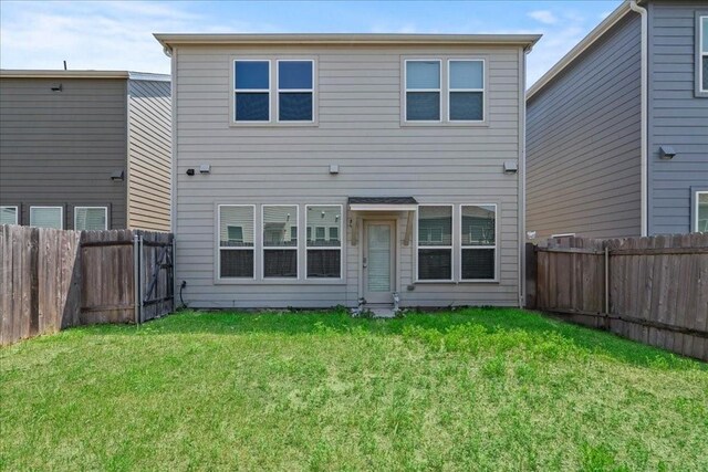 back of house featuring a yard