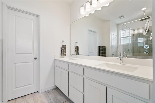 bathroom featuring vanity and a shower with shower door