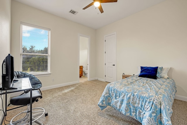 carpeted bedroom with connected bathroom and ceiling fan