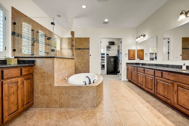 bathroom featuring tile patterned flooring, vanity, and separate shower and tub