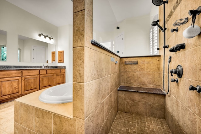 bathroom featuring vanity, tile patterned flooring, and tiled shower