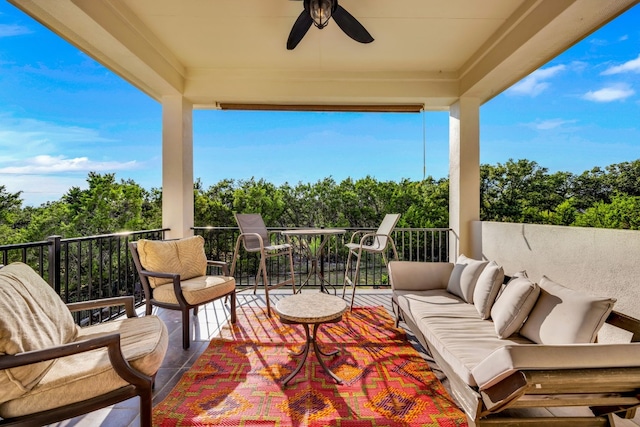 balcony with an outdoor living space and ceiling fan