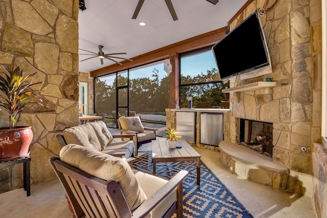 living room with ceiling fan and a fireplace