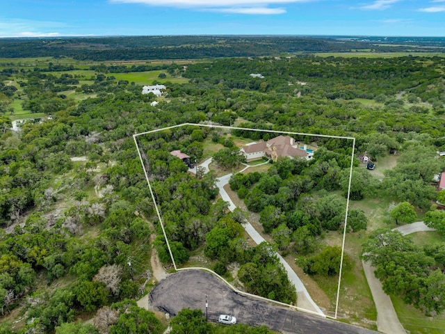birds eye view of property featuring a forest view