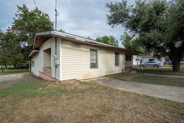 view of side of home with a lawn