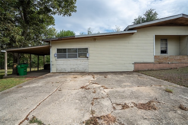 view of home's exterior featuring a carport