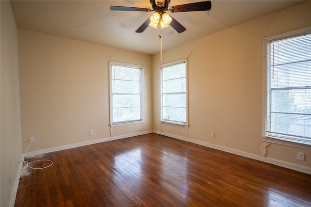 spare room featuring dark wood-type flooring and ceiling fan