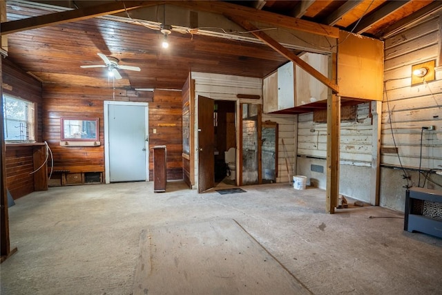1816 Davis St, Taylor, TX 76574 - unfurnished living room with wood walls, a ceiling fan, and lofted ceiling