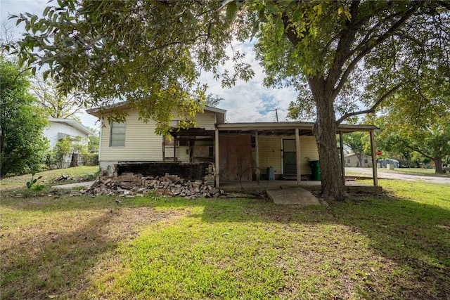 back of house with a yard and a patio