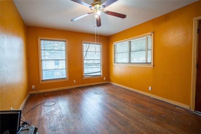 unfurnished room featuring dark wood-type flooring and ceiling fan