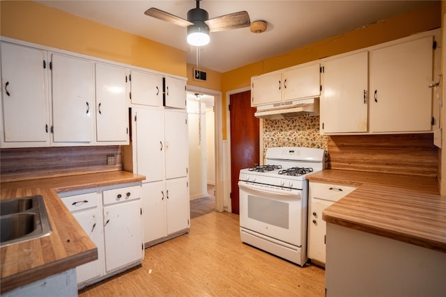 kitchen with white cabinetry, light hardwood / wood-style flooring, backsplash, ceiling fan, and white range with gas stovetop