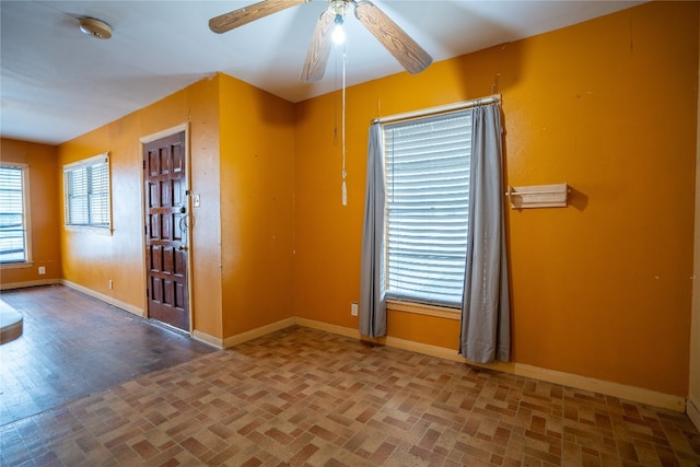 empty room with hardwood / wood-style floors and ceiling fan