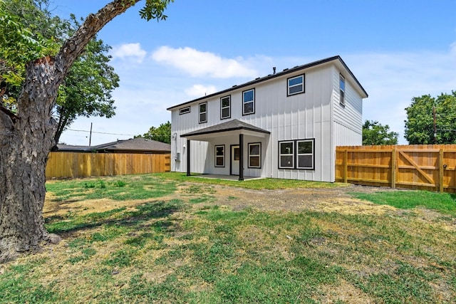 rear view of house with a yard