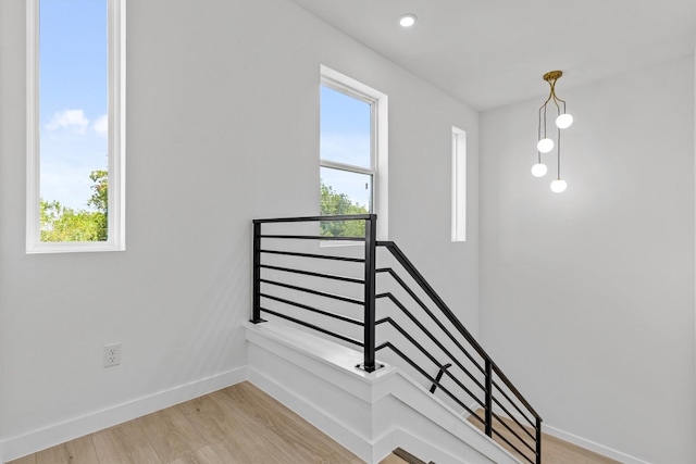 stairs with hardwood / wood-style floors