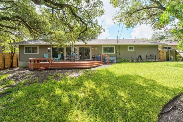 7110 Sungate Dr, Austin, TX 78731 - rear view of property featuring fence, a yard, and a wooden deck