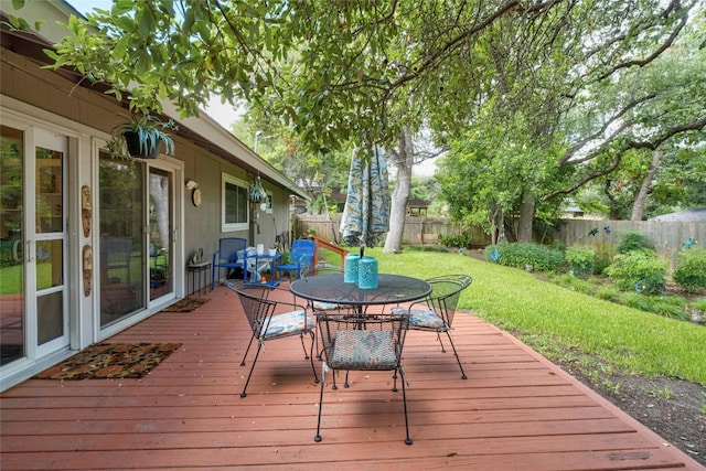 7110 Sungate Dr, Austin, TX 78731 - wooden deck with a fenced backyard, outdoor dining area, and a yard