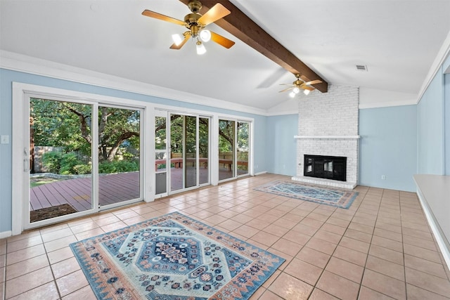 unfurnished living room featuring a fireplace, lofted ceiling with beams, light tile patterned floors, and a wealth of natural light