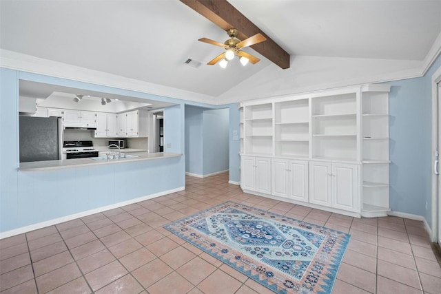 unfurnished living room with lofted ceiling with beams, ceiling fan, and light tile patterned floors