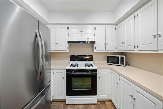 7110 Sungate Dr, Austin, TX 78731 - kitchen with stone finish floor, light countertops, white cabinetry, under cabinet range hood, and appliances with stainless steel finishes