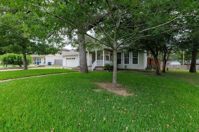 view of front of property featuring a porch, a garage, and a front lawn