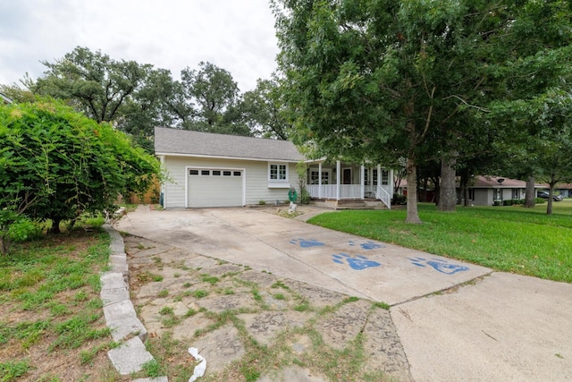 view of front of home featuring a garage, a front lawn, and covered porch