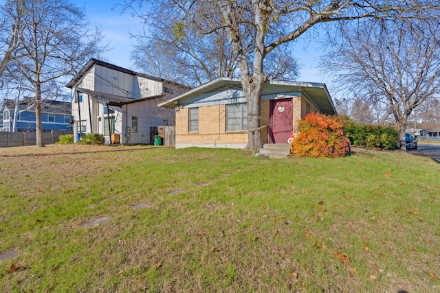 rear view of property with a lawn