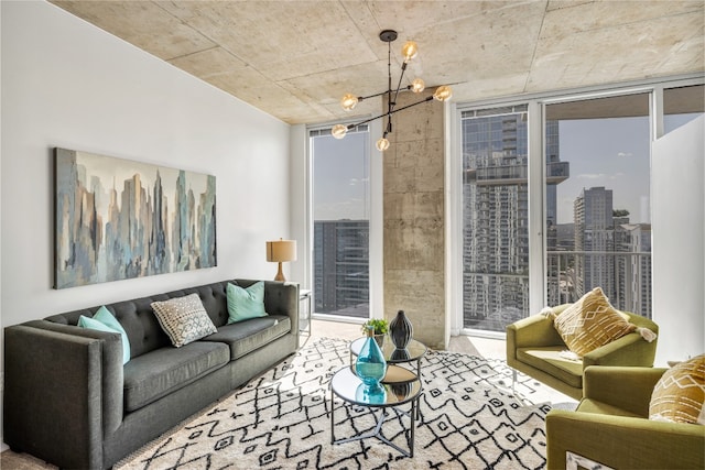 living room featuring a healthy amount of sunlight, a wall of windows, and a chandelier