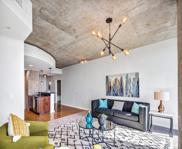 living room with an inviting chandelier and hardwood / wood-style flooring