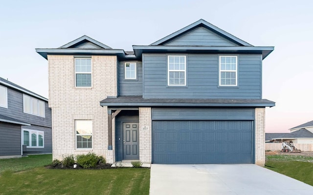 view of front of house featuring a garage, brick siding, concrete driveway, and a front yard