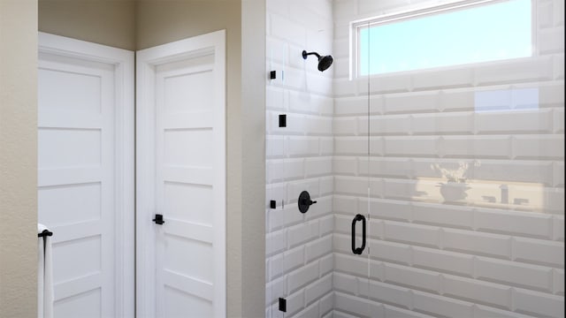 bathroom with a shower with door