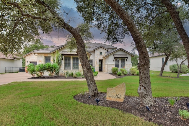 view of front of house with a lawn and a garage