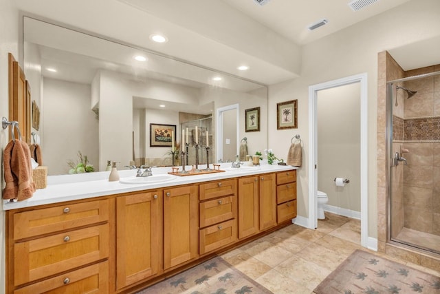 bathroom with tile patterned flooring, an enclosed shower, vanity, and toilet