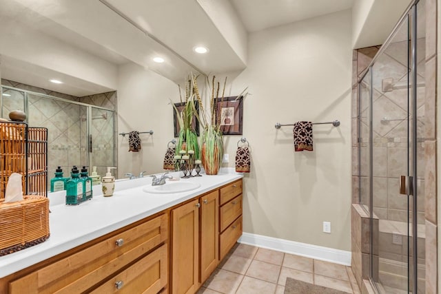 bathroom with an enclosed shower, vanity, and tile patterned floors