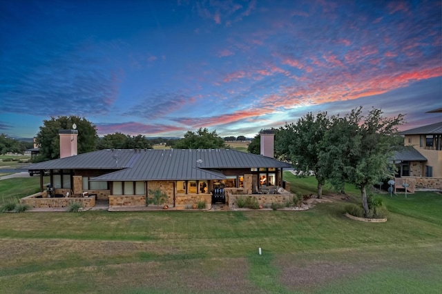 view of front of home featuring a patio area and a lawn