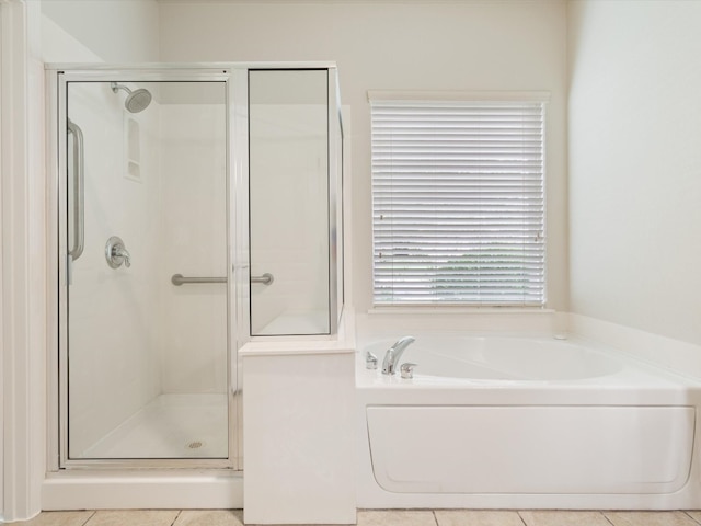 bathroom with independent shower and bath and tile patterned flooring