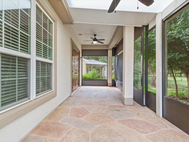 sunroom featuring ceiling fan