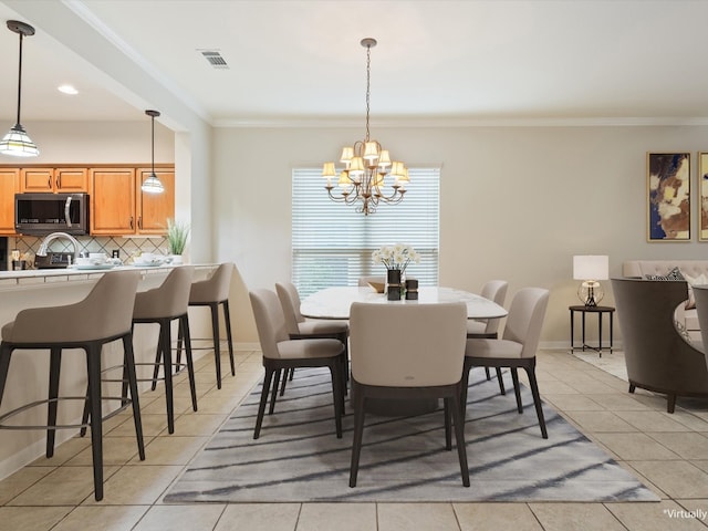 tiled dining room featuring crown molding and a notable chandelier