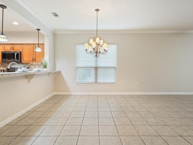 tiled empty room featuring crown molding and a notable chandelier