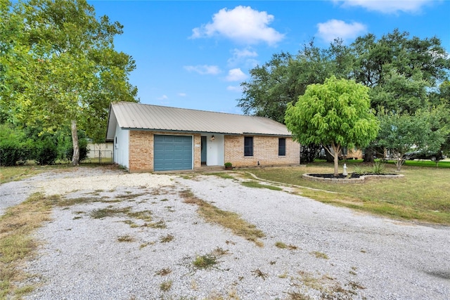 ranch-style house featuring a garage and a front lawn