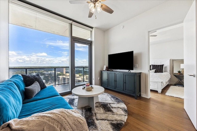 44 E Ave Unit 1709, Austin, TX 78701 - living area featuring healthy amount of natural light, a wall of windows, ceiling fan, and wood finished floors