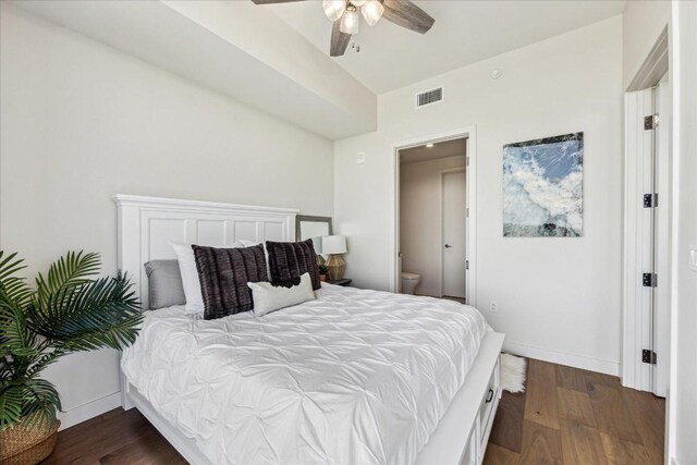 bedroom featuring ceiling fan, dark hardwood / wood-style floors, and ensuite bath