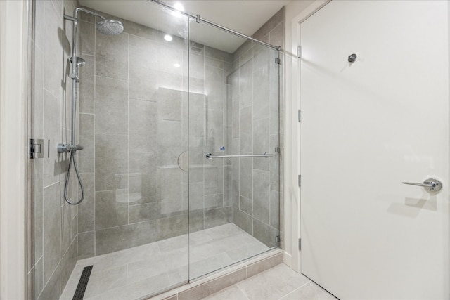 bathroom with walk in shower and tile patterned flooring