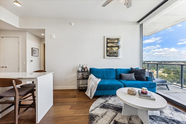 44 E Ave Unit 1709, Austin, TX 78701 - living area featuring a ceiling fan, expansive windows, wood finished floors, and baseboards