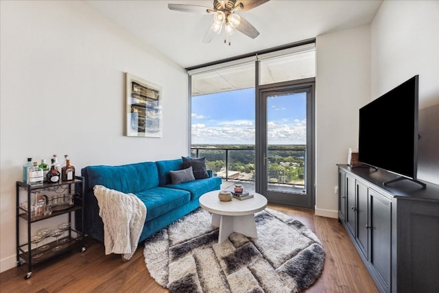 44 E Ave Unit 1709, Austin, TX 78701 - living room with ceiling fan, wood finished floors, expansive windows, and baseboards