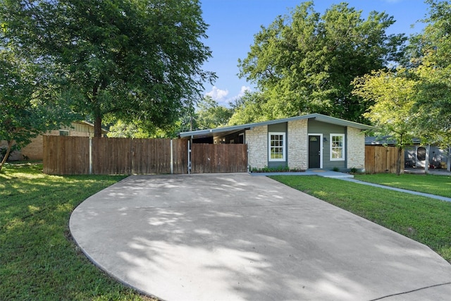 single story home featuring a carport and a front lawn