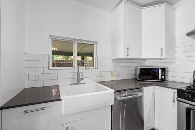 kitchen with white cabinetry, backsplash, and stainless steel appliances