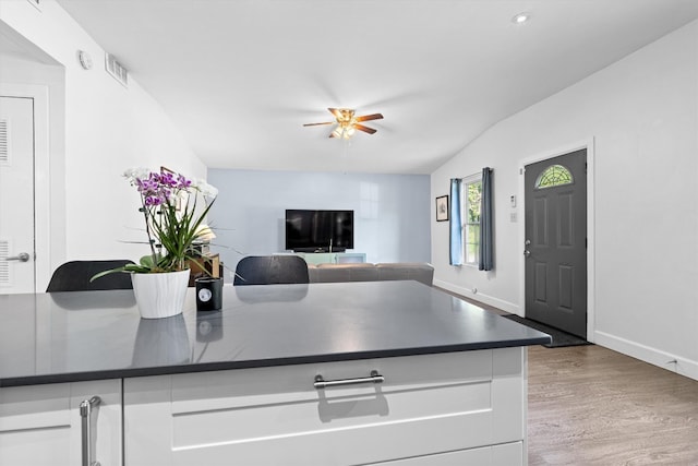 kitchen featuring ceiling fan, white cabinetry, and light hardwood / wood-style flooring